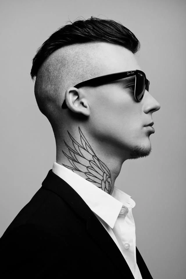 necklace neck wings man with tattoos in a suit