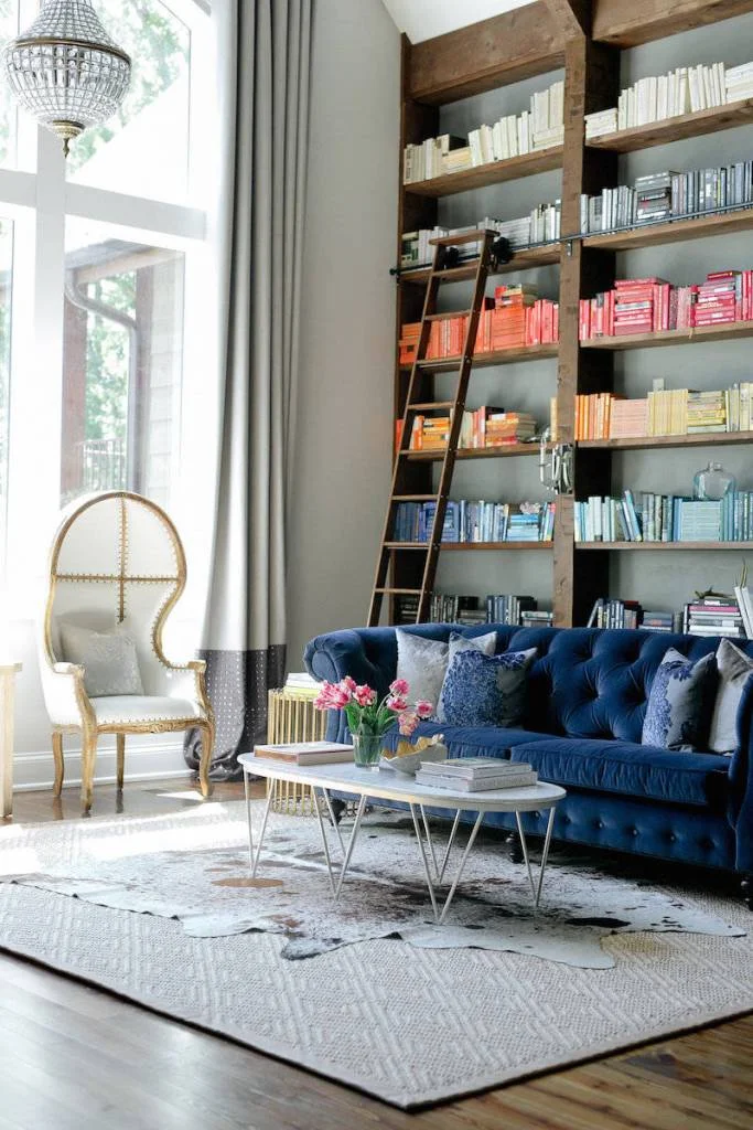 Blue Velvet Chesterfield Sofa Near Bookcase