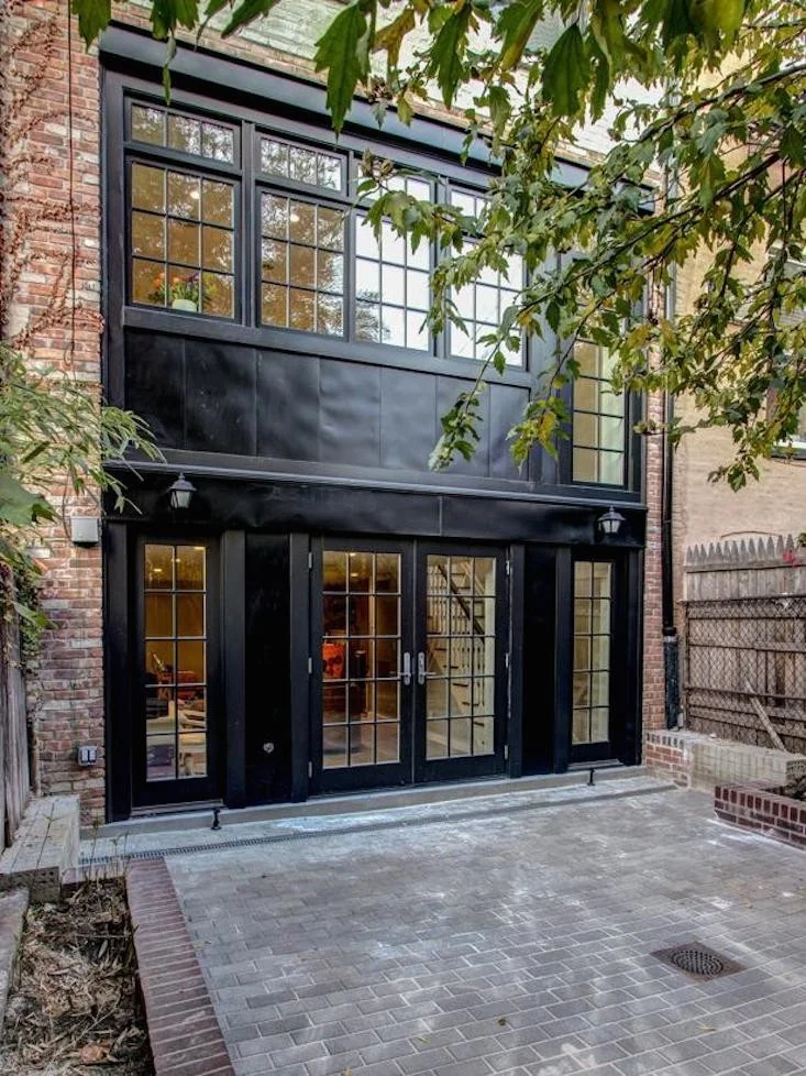 Metal Trim Facade Black House with Brick Wall
