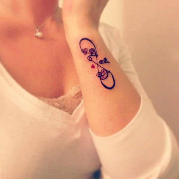 Infinity Music Tattoo On Girl Side Wrist