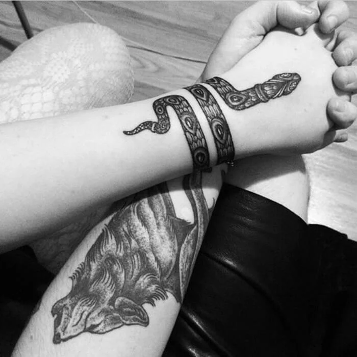 Rolled Snake Around a Hand Tattoo