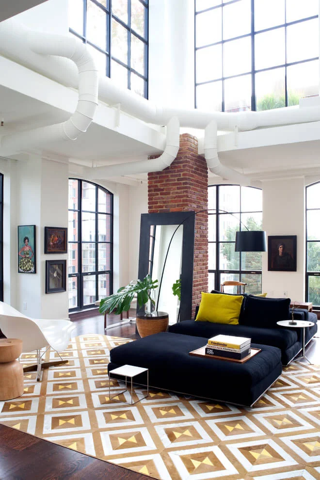 black sofa colorful rug