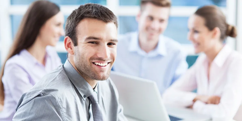 Businessman with coworkers in background