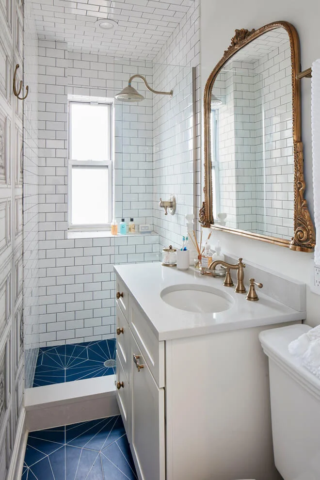 Gold Accents and Patterned Floors In Bath