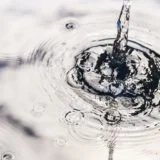 Rainwater harvesting in a large polymer tank on the terrace of a house. Ripples on the surface of water. Aquaphobia – fear of water.