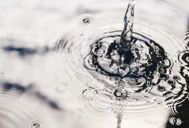 Rainwater harvesting in a large polymer tank on the terrace of a house. Ripples on the surface of water. Aquaphobia – fear of water.