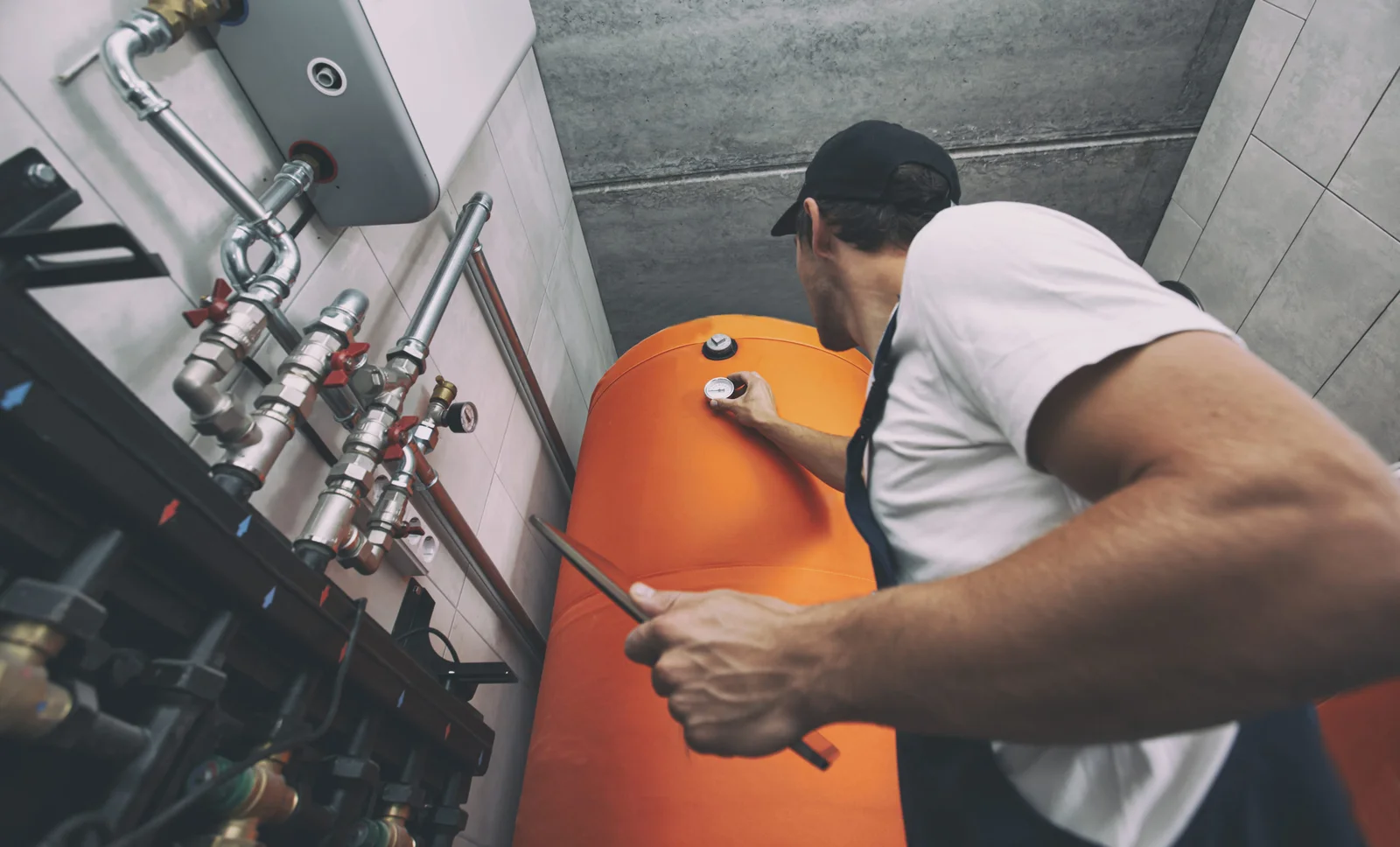 The technician checking the heating system in the boiler room wi