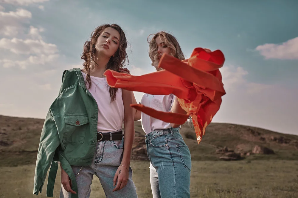 High fashion portrait of two stylish beautiful woman in trendy j
